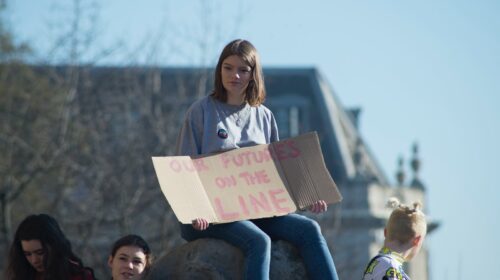 woman holding cardboard signage