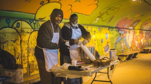 two men wearing aprons